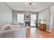 Comfortable living room with hardwood floors, a faux fireplace, and plenty of natural light from the many windows at 225 Mapledale Trl, Sharpsburg, GA 30277