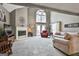 Bright living room with a fireplace, large windows, and comfortable seating arrangement at 225 Mapledale Trl, Sharpsburg, GA 30277