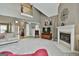 Spacious living room featuring a fireplace, neutral carpet, high ceilings, and a view of the mezzanine above at 225 Mapledale Trl, Sharpsburg, GA 30277