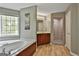 Spacious main bathroom with tub, separate shower, and vanity with ample counter space at 225 Mapledale Trl, Sharpsburg, GA 30277