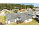 Aerial view of a house with backyard deck, seating, and landscaped lawn at 11970 Fairway Overlook, Fayetteville, GA 30215