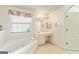 Relaxing bathroom featuring a large soaking tub and vanity area at 11970 Fairway Overlook, Fayetteville, GA 30215
