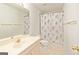 Clean bathroom featuring a vanity, toilet, and shower with floral curtains at 11970 Fairway Overlook, Fayetteville, GA 30215