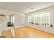 Bright dining room featuring wood floors, a large window and adjacent living area at 11970 Fairway Overlook, Fayetteville, GA 30215