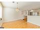Inviting dining room with hardwood floors, view to the kitchen and stylish chandelier at 11970 Fairway Overlook, Fayetteville, GA 30215