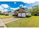 Brick home featuring a two-car garage, manicured lawn and adjacent home with white siding at 11970 Fairway Overlook, Fayetteville, GA 30215