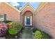 Inviting front entrance with a decorative door and manicured landscaping at 11970 Fairway Overlook, Fayetteville, GA 30215