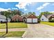 Charming brick home featuring an attached two car garage and a well-manicured lawn at 11970 Fairway Overlook, Fayetteville, GA 30215