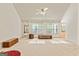 Bright living room with large windows and neutral carpet flooring at 11970 Fairway Overlook, Fayetteville, GA 30215