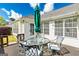 Outdoor patio with furniture including a glass table, chairs, and large green umbrella at 11970 Fairway Overlook, Fayetteville, GA 30215