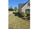Exterior view of the backyard with a retaining wall and landscaping at 35 Charleston Ln, Covington, GA 30016