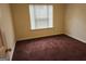 A bedroom featuring carpet flooring and natural light from a bright window at 2337 Carousel Park Dr, Morrow, GA 30260