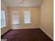 A bedroom with carpet flooring and two bright windows at 2337 Carousel Park Dr, Morrow, GA 30260