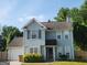 Charming two-story home with a blue exterior, attached garage, and well-manicured landscaping at 2337 Carousel Park Dr, Morrow, GA 30260