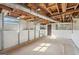 Unfinished basement space with visible ceiling beams, white walls and concrete floor and door to the outside at 264 Rockin Hill Sw Dr, Marietta, GA 30060