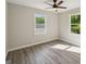 A bright bedroom with gray wood-look flooring and lots of natural light at 264 Rockin Hill Sw Dr, Marietta, GA 30060