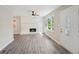 Bright living room with a brick fireplace, hardwood floors, and large windows at 264 Rockin Hill Sw Dr, Marietta, GA 30060