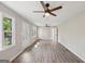 Bright living room featuring new gray flooring, ceiling fan, and lots of natural light at 264 Rockin Hill Sw Dr, Marietta, GA 30060