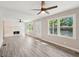 Spacious living room featuring wood floors, brick fireplace, and large windows at 264 Rockin Hill Sw Dr, Marietta, GA 30060