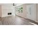 Bright living room with a brick fireplace, hardwood floors, and neutral paint at 264 Rockin Hill Sw Dr, Marietta, GA 30060
