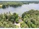This aerial view captures the lakefront estate, showcasing its private dock, lush landscaping, and serene waterfront setting at 270 Polk Rd, Covington, GA 30014
