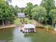 Panoramic aerial view showcases a beautiful lakeside home with private dock, lush green lawn, and mature trees for privacy at 270 Polk Rd, Covington, GA 30014