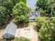This aerial shot shows the lakefront home with a lush landscape, dock, and ample parking nestled amongst mature trees at 270 Polk Rd, Covington, GA 30014