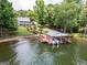 Aerial view of the home with the private dock, patio, landscaping, and path to the lake at 270 Polk Rd, Covington, GA 30014