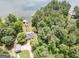 This aerial view captures a stunning lakefront home with private dock, nestled amongst mature trees for ultimate privacy at 270 Polk Rd, Covington, GA 30014