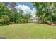 Beautiful backyard with a large lawn and wooded landscaping surrounding the house at 270 Polk Rd, Covington, GA 30014