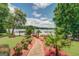 A garden path through landscaped grounds leads to a lake with docks, framed by mature trees at 270 Polk Rd, Covington, GA 30014