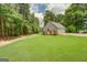 Spacious backyard featuring a private putting green and detached garage with a double door at 270 Polk Rd, Covington, GA 30014