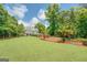 Expansive backyard with lush green lawn and landscaped garden beds at 270 Polk Rd, Covington, GA 30014