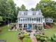 Expansive backyard with patio, outdoor kitchen, lush landscaping, and screened in porch great for entertaining and relaxing at 270 Polk Rd, Covington, GA 30014