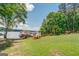 Lush lawn and landscaping leading to a private dock on a serene lake at 270 Polk Rd, Covington, GA 30014