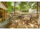 Backyard fire pit area with stone benches, a firepit, and wooded scenery at 270 Polk Rd, Covington, GA 30014