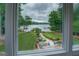 View from the window of a meticulously landscaped yard and lake beyond at 270 Polk Rd, Covington, GA 30014