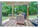 Backyard grilling area with brick pavers, a grill, prep station, and lush green landscaping at 270 Polk Rd, Covington, GA 30014
