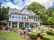 This backyard boasts a spacious patio, screened in porch and outdoor kitchen, perfect for outdoor enjoyment and gatherings at 270 Polk Rd, Covington, GA 30014
