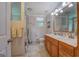 Bright bathroom with double vanity, large mirror, shower, and tiled floor at 270 Polk Rd, Covington, GA 30014