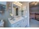 Bright bathroom featuring a white vanity with marble countertop and views of the hallway at 270 Polk Rd, Covington, GA 30014