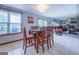 Open dining area featuring wood table set next to a large window and adjacent to the living room at 270 Polk Rd, Covington, GA 30014