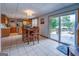 Inviting dining area connects to a kitchen and patio, offering tile flooring, wooden furniture, and abundant natural light at 270 Polk Rd, Covington, GA 30014