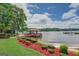Picturesque dock with boat slip provides direct lake access, complemented by a landscaped yard and wooded shoreline at 270 Polk Rd, Covington, GA 30014
