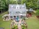 Back of house with large patio that includes an outdoor kitchen, covered dining, and nice landscaping at 270 Polk Rd, Covington, GA 30014