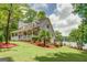 Beautiful lakeside home with a welcoming front porch, manicured lawn, and mature trees at 270 Polk Rd, Covington, GA 30014