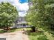 Charming two-story home featuring a inviting front porch, lush landscaping, and a well-manicured front yard at 270 Polk Rd, Covington, GA 30014