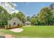 View of the home's front exterior with a lush lawn and a putting green at 270 Polk Rd, Covington, GA 30014