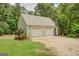 Detached two-car garage with ample parking space and an additional side door at 270 Polk Rd, Covington, GA 30014