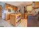 Spacious kitchen with wooden cabinets, stainless steel appliances, granite counters, and a functional island for meal preparation at 270 Polk Rd, Covington, GA 30014